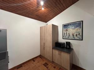 a room with a cabinet and a painting on the wall at Chalet des Cinq in Samoëns +23 photos
