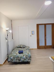 a bedroom with a bed in the middle of it at Appartement entier au rez- de- chaussée 