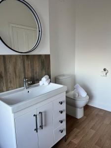 a bathroom with a white sink and a toilet at 180b Wells Road in Bristol