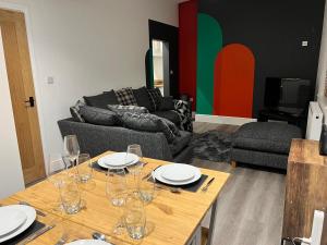 a living room with a table with wine glasses on it at 180b Wells Road in Bristol