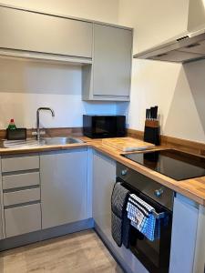 a kitchen with a sink and a stove at 180b Wells Road in Bristol +5 photos