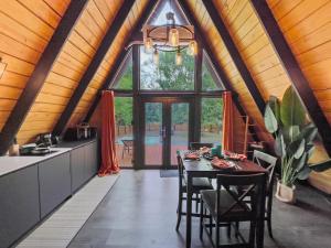 a kitchen and dining room with a table in a house at Africa787 A Frame Wood House With Pool in Lajas in Lajas