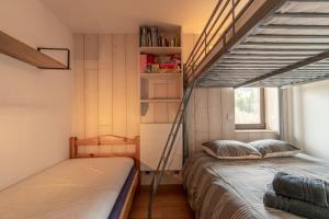 a bedroom with two beds and a book shelf at Apartment Grizzly - 2 bedrooms - Ski in/out- Les Gets in Les Gets