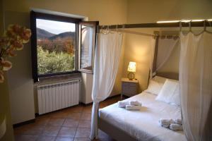 a bedroom with a canopy bed and a window at Villa Gradoni in Monticelli Brusati +144 photos