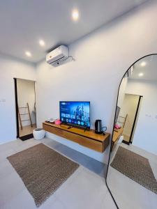 a living room with a flat screen tv on a wall at Pinggan harmoni in Baturaja