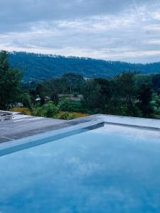 a swimming pool with a view of a mountain at Pinggan harmoni in Baturaja