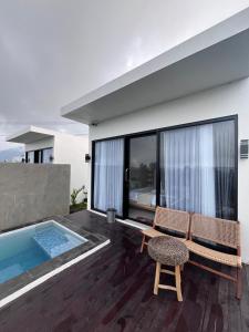 a patio with a bench and a swimming pool at Pinggan harmoni in Baturaja
