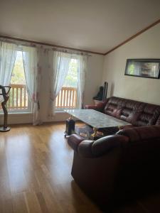a living room with a couch and a table at Gamle bygdevei 198b in Oslo