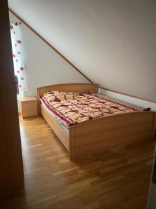 a bed in a room with a wooden floor at Gamle bygdevei 198b in Oslo