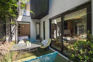 a patio with a table and chairs and a table at Melbourne suites - Zen Oasis or skyline views in Melbourne