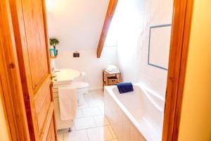 a bathroom with a tub and a toilet and a sink at Domaine de la Croix Tibi in Guilly +14 photos