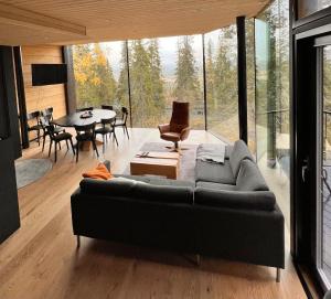 a living room with a couch and a table at Arctic Skyline Villa in Pudasjärvi