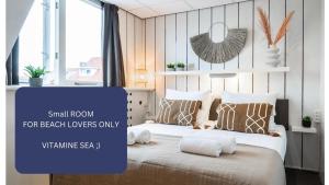 a large bedroom with a large bed with pillows at Affordable Private BedRoom Near the Beach in Zoutelande