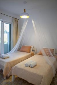 two beds sitting next to each other in a bedroom at Fotis House 3 in Afantou