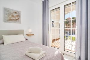 a bedroom with a bed and a large window at Apto 2 Almoraide Suites in Nerja +23 photos
