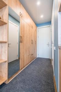 an empty room with wooden walls and doors at Atrium New Gudauri GN in Gudauri +23 photos