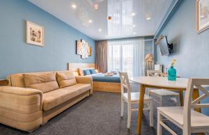 a living room with a couch and a table and a bed at Atrium New Gudauri GN in Gudauri