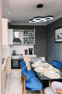 a kitchen with a dining table and blue chairs at MELVİN HOMe in Istanbul +59 photos