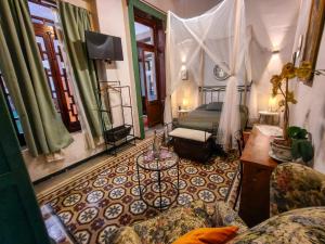 a bedroom with a bed and a couch and a table at Villa Catrina in Morelia +3 photos