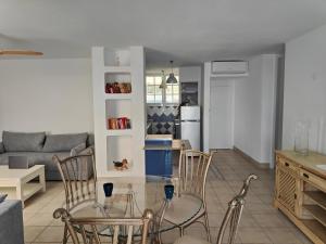 a living room with a couch and a table and chairs at Azahara Beach in Arona