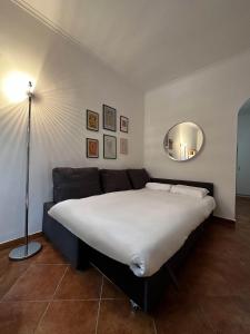 a bedroom with a large bed and a couch at La Casetta di Via Sannio in Rome