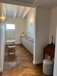 a kitchen with a sink and a table in a room at My Maison 49 in Empoli