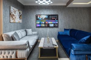 a living room with two couches and a tv at MELVİN HOMe in Istanbul