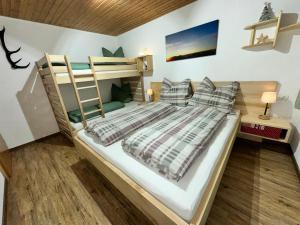 a bedroom with a bunk bed with a ladder at apart-gerlos in Gerlos