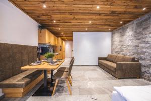 a dining room with a table and a couch at Alpine Essence - Luxury Apartment in Zell am See Center in Zell am See +15 photos