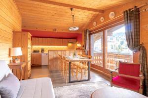 a kitchen and living room with a table and chairs at Six-Deniers in Les Gets