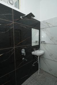 a bathroom with a sink and a mirror at Taposthalam Sacred Retreat Hotel in Rishikesh in Rishīkesh