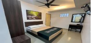 a bedroom with a bed and a ceiling fan at HP Usima Forest Resort Melaka in Ayer Keroh +26 photos
