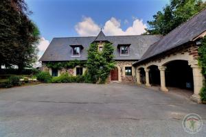 a large stone house with a large driveway at Manoir de la droulinais in Bruz