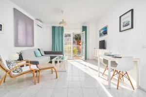 a living room with a couch and a table at Apto 1 Almoraide Suites in Nerja