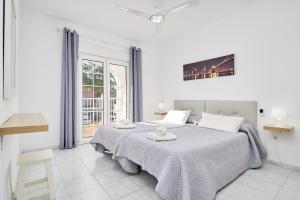 a white bedroom with a large bed and a window at Apto 1 Almoraide Suites in Nerja +23 photos