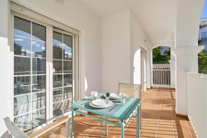a balcony with a table and chairs on it at Apto 1 Almoraide Suites in Nerja