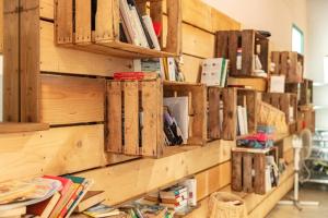 a library with wooden shelves with books on it at Camping Clos Cottet in Angles