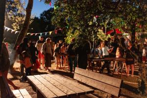 a crowd of people standing around a picnic table at Camping Clos Cottet in Angles +50 photos