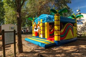 a playground with a inflatable slide in a park at Camping Clos Cottet in Angles