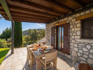 een tafel op de patio van een huis bij Anemones Villas by Omikron Selections in Spanokhórion