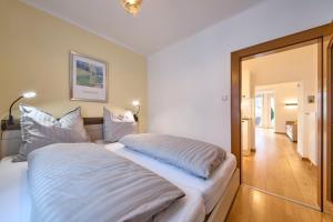 a bedroom with a large bed with white sheets at Apartment Sandra in Schwarzach im Pongau
