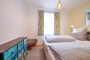 a bedroom with a bed and a dresser and a window at Apartment Sandra in Schwarzach im Pongau +51 photos