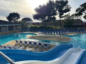 a swimming pool with chaise lounge chairs and a swimming pool at Au petit bonheur in Calvisson