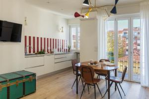 a kitchen and dining room with a table and chairs at La Bice in Savigliano