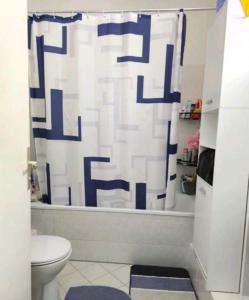 a bathroom with a toilet and a shower curtain at Comfortable room in a quiet apartment, exclusively for women in Dresden