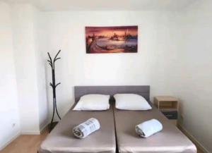 a bed in a room with two pillows on it at Comfortable room in a quiet apartment, exclusively for women in Dresden