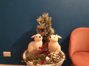 two stuffed animals sitting next to a christmas tree at Fiori e Frutti Guest Home in Almese