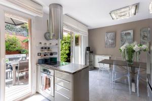 a kitchen with a table and a dining room at Les Villas De Mandelieu in Mandelieu-La Napoule