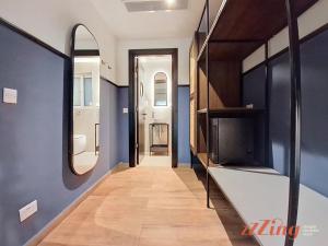 a hallway of a house with blue walls and a mirror at South 32 Hotel by Zzzing in Birżebbuġa