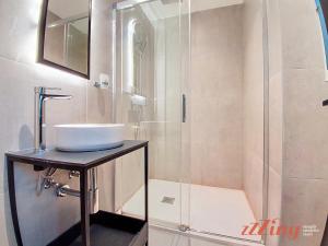 a bathroom with a sink and a shower at South 32 Hotel by Zzzing in Birżebbuġa +29 photos